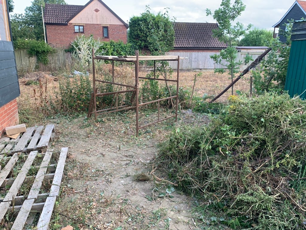 Overgrown plot in Kelsale with old metal frame, before and after clearing (after)